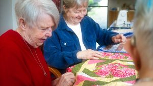 Two woman working on a quilt at SCOC